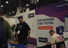 The booth of Puprl with John Hunt talking with customers